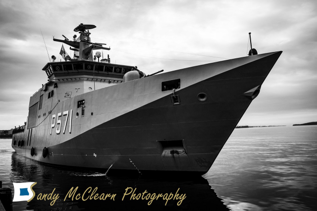 Patrol ship approaching a wharf. 