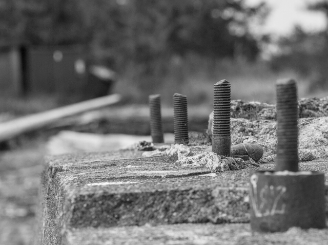 Closeup of rusty pier support bolts