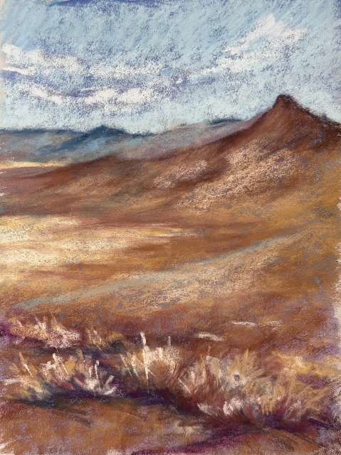 A pastel study in vertical format. Mountains and desert. Brushes in the foreground. 