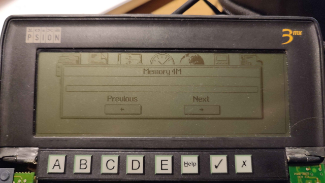 Picture of a Psion Series 3mx, slightly disassembled but running. The screen shows that the machine has 4MB RAM, although there is nothing in it.